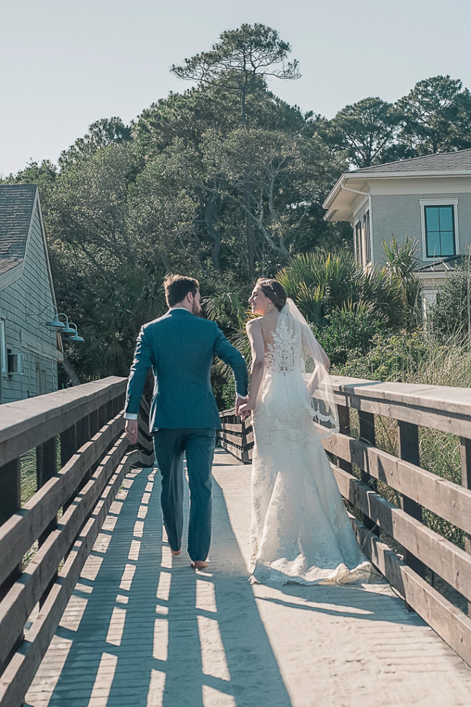 couple leaving their beach wedding